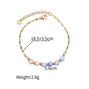 Detail showing gold stainless steel bracelet with colorful cat-eye star beads and lobster clasp