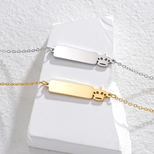 Gold and silver square plate necklaces with crown charms on a white display block