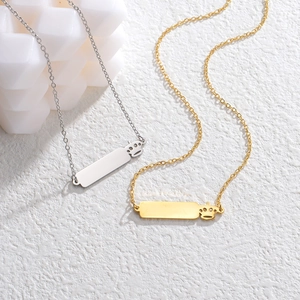 Gold and silver stainless steel necklace featuring crown and rectangular bar pendant