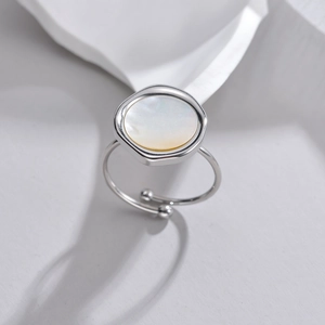 Macro view of minimalist adjustable silver ring with irregular mop shell inlay