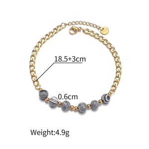 Detail of beaded Cuban link bracelet in gold stainless steel with striped agate beads