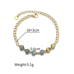 Close-up of Macaron beaded gold chain bracelet with colorful spiral glass beads