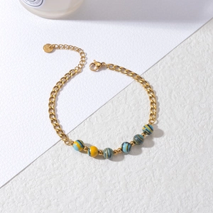 Detailed macro view of gold stainless steel bracelet with colorful macaron beads