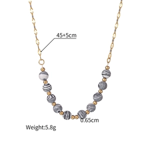Detail shot of a bohemian gold chain necklace with 11 striped beads and sizing data
