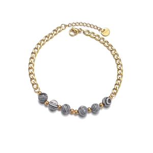 Fashionable gold Cuban chain bracelet with black and white marbled beads and lobster clasp