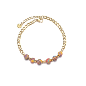 Close-up of golden Cuban chain bracelet with colorful swirl beads and S.Steel tag