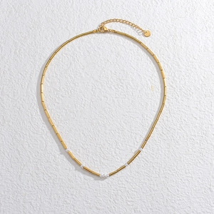 Detail of 14K gold-plated stainless steel tube necklace with small white pearls