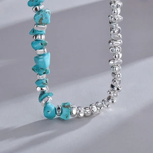 Ethnic stainless steel necklace with irregular blue turquoise beads and silver metal accents
