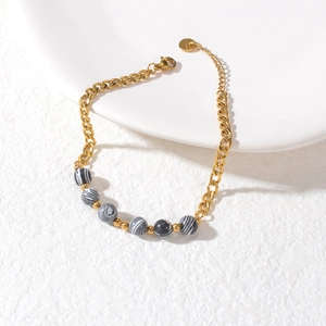 Elegant gold stainless steel beaded bracelet with marble-textured macaron charm beads