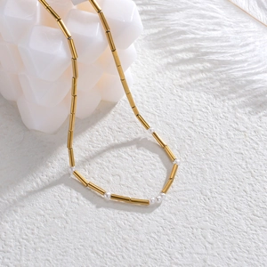 14K gold plated heart necklace with cylinder beads and pearls on white background