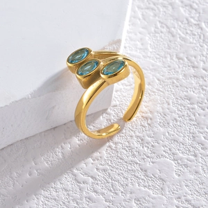 Detail of vintage gold-tone ring featuring three oval blue zircons on stone prop