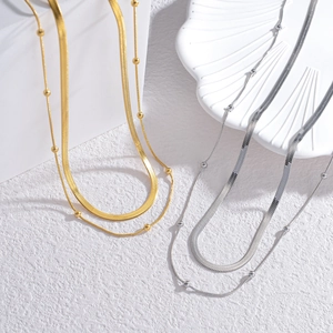 Double-layered stainless steel necklace featuring flat snake chain and beaded link style