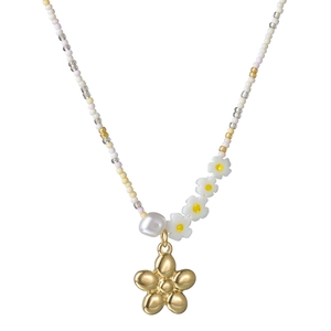 Macro shot of colorful beads and white resin daisies with a golden flower pendant necklace