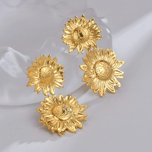 Four-piece set of golden sunflower earrings with realistic textured petals and centers