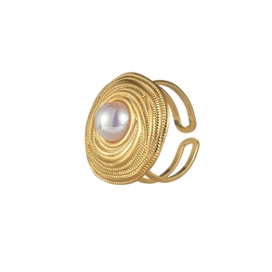 Detail of vintage gold starfish ring featuring spiral texture and white pearl center