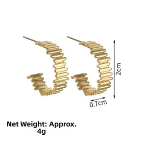 Detailed close-up of 2cm gold C-shaped hoop earrings with textured ripple design