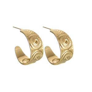 Detail of gold-plated geometric stud earrings with engraved sunburst and fringe patterns