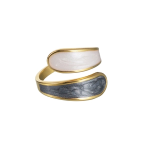 Detail of gold wrap ring featuring white and grey enamel texture on white background