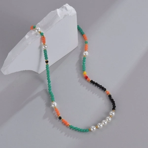 Detail of beaded necklace with 14K gold accents, pearls and colorful natural stones