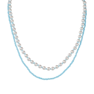 Double-layered necklace with white pearls and light blue beads on a clean white background