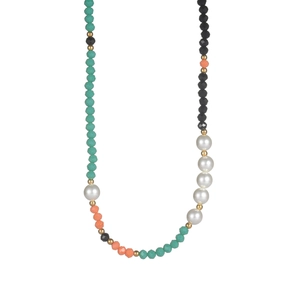 Detail of colorful beaded necklace with green stones and white pearls on a gold chain