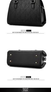 Detail view of black handbag with geometric stitching and gold protective base studs