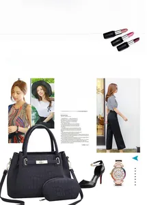 Détail du sac à main noir croco avec fermoir doré et petite pochette zippée assortie