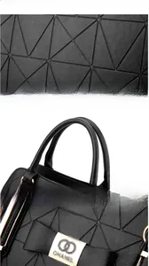 Detail of black PU leather handbag showing geometric stitching and gold logo buckle