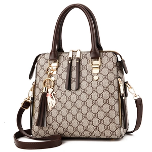 Women's brown GD monogram faux leather tote bag with tassel and gold hardware