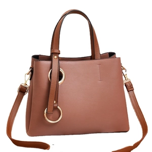 Fashionable contrast color bucket bag in dark brown with gold metal ring accents