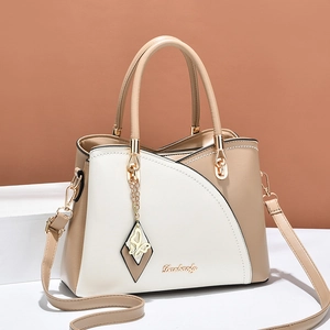 Chic beige and white color-block leather handbag with gold logo and butterfly charm