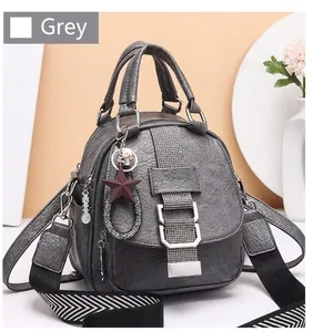 Grey soft leather backpack detail with rhinestone decor and chevron patterned strap
