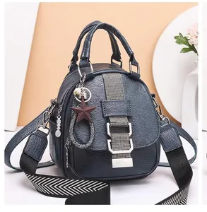 Blue soft leather backpack detail with star pendant and striped shoulder strap