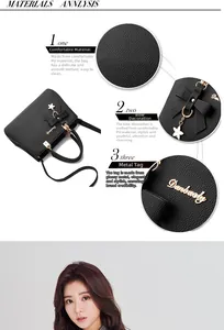 Detail of black PU leather bag with lychee texture and golden floral bow pendant