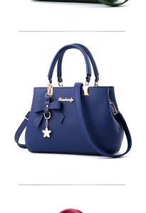 Detail view of royal blue lychee pattern faux leather handbag with star pendant