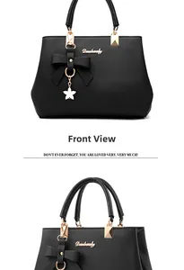 Macro detail of black PU leather texture with bow decoration and golden star pendant