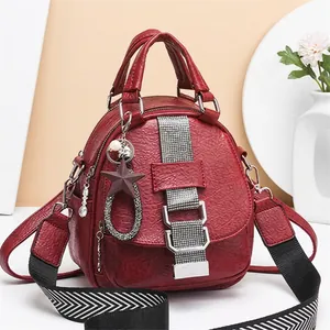Red patent leather mini backpack with star charm and geometric pattern wide strap
