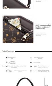 Close-up of vintage printed crossbody bag with golden heart clasp and detailed monogram pattern