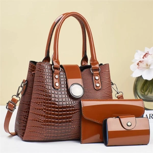 Detailed view of the three-piece brown faux lizard leather tote bag with wallet and card holder