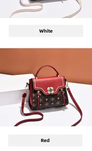 Detail view of vintage patterned crossbody bag with red leather flap and golden floral buckle
