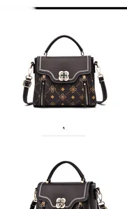 Detail of dark brown leather handbag with gold floral print and clover turn-lock closure