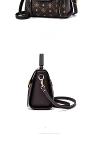 Detail of vintage brown printed crossbody bag with gold hardware and side view