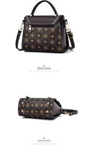 Detail view of the brown leather bag showing the rear zipper and metal bottom feet