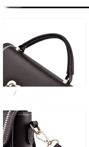 Detail of black crossbody bag with white leaf embroidery and gold metal hardware