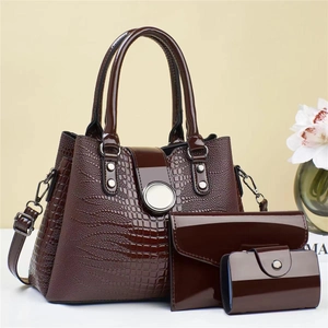Three-piece women's handbag set in wine red faux lizard skin with gold clasp details