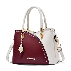 Women's burgundy and white leather handbag with butterfly charm and gold logo