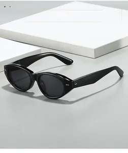 Detail of vintage black cat-eye sunglasses with wide temples and silver rivet accents