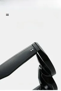 Detailed view of glossy black frames with metal rivet accents and reinforced hinges