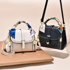 Elegant embossed tote bag with scarf handle and gold hardware in black and cream beige