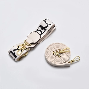 Adjustable wide letter print strap and slim cream leather shoulder strap with gold hardware